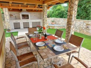 a table and chairs on a patio at Apartment House Liznjan in Ližnjan +12 photos