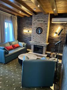 a living room with a couch and a fireplace at Шале Вершина in Palyanytsya