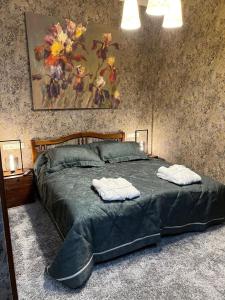 a bedroom with a bed with two towels on it at Шале Вершина in Palyanytsya +17 photos