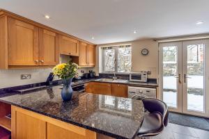 a kitchen with a vase of flowers on a counter at Finest Retreats - Cedar Tree Cottage in Clocaenog +11 photos
