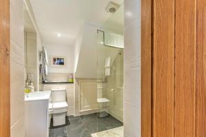 a bathroom with a sink and a toilet and a shower at Finest Retreats - Cedar Tree Cottage in Clocaenog
