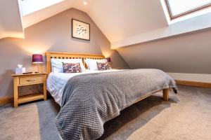 a bedroom with a bed in a attic at Finest Retreats - Cedar Tree Cottage in Clocaenog