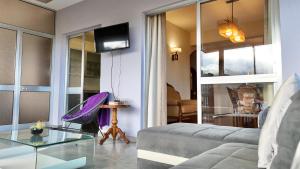 a living room with a couch and a glass table at The Gray House in Bicas