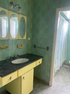 a bathroom with a sink and two mirrors at Casa en Miramar in Miramar