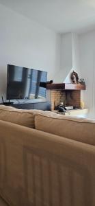 a living room with a couch and a fireplace at Thalassa in Perdika