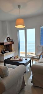 a living room with a couch and a table at Thalassa in Perdika