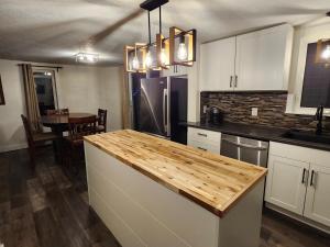 a kitchen with white cabinets and a counter top at Getaway by the bay in Owen Sound