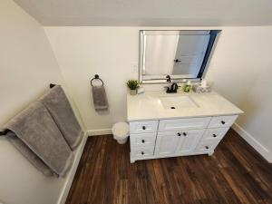 a bathroom with a white sink and a mirror at Getaway by the bay in Owen Sound +13 photos