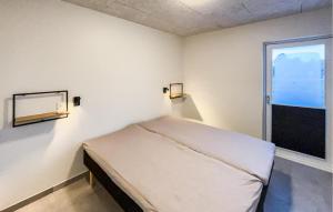 a small room with a bed and a window at Awesome Home In Ringkøbing With Wifi in Ringkøbing