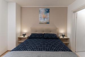 a bedroom with a bed and a painting on the wall at House Cerovac in Nedeščina +14 photos