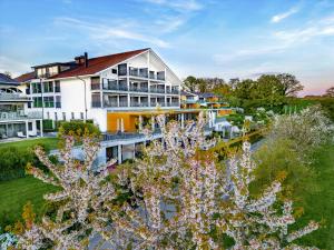 an aerial view of a building with flowers in the foreground at Wellnesshotel Golfpanorama in Lipperswil