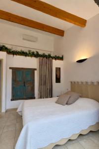 a bedroom with a large white bed in a room at Domaine De Blancardy in Moulès-et-Baucels +51 photos