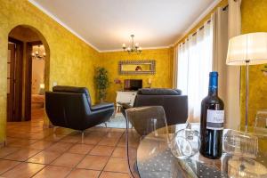 a living room with a bottle of wine on a glass table at Apartamento Vulcano in Adeje +7 photos