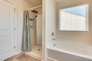 a white bathroom with a tub and a shower at Guest House Haven with Gazebo in Riverdale +15 photos