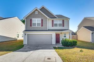 a house with a garage in a yard at Guest House Haven with Gazebo in Riverdale