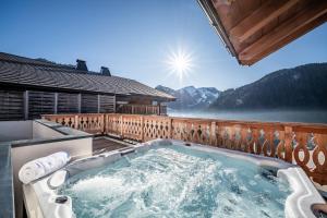 a hot tub on the deck of a house at Apartment Danton, Châtel - by EMERALD STAY in Châtel