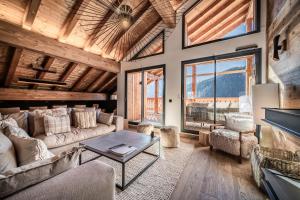 a living room with a couch and a table at Apartment Danton, Châtel - by EMERALD STAY in Châtel +36 photos
