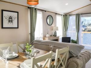 a living room with a table and a couch at Waterfoot Lodge W09 in Amotherby