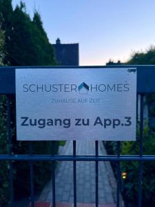 a sign on a gate with a sign on it at Appartement 3 - geräumige Wohnung mit eigener Küche, Bad und Gartenblick in Salzgitter +4 photos
