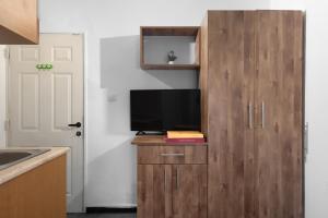 a kitchen with a cabinet with a television on it at Bella Vista House - בלה ויסטה האוס in Eilat