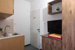 a kitchen with a sink and a tv on a counter at Bella Vista House - בלה ויסטה האוס in Eilat +26 photos