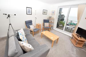 a living room with a couch and chairs and a television at 1 Bed in Langland oc-hh147 in Newton