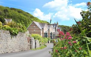 a house on a street with a stone wall at 1 Bed in Langland oc-hh147 in Newton