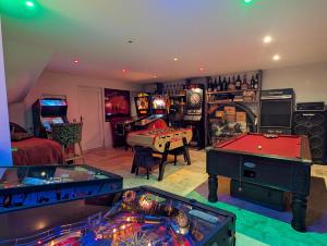 a living room with arcade games and pool tables at Hostelry restaurant privé in Écully