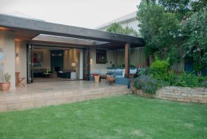 a backyard with a patio with a wooden deck at Wessels House in Cape Town