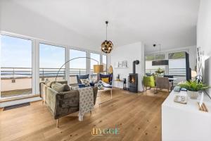 a living room with a view of the ocean at Penthouse Hygge Meerblick - Olpenitz in Olpenitzdorf