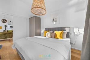 a bedroom with a large bed with yellow pillows at Penthouse Hygge Meerblick - Olpenitz in Olpenitzdorf