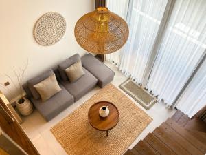 a living room with a couch and a table at KAIA Canggu in Canggu