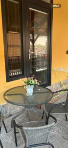 a table with chairs and a vase of flowers on it at UbytkoMácháč in Staré Splavy