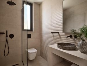 a bathroom with a toilet and a sink and a shower at Villa Theta by Villa Select in Kalamaki +25 photos
