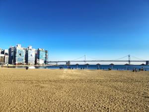 a view of a beach with a bridge in the background at Gwanganli Breeze Bay in Kwangan-dong
