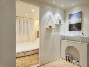 a bedroom with a bed and a fireplace at Gwanganli Breeze Bay in Kwangan-dong