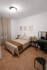a bedroom with a large bed and a piano at Hostal Prada in Madrid