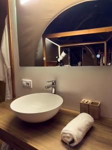 a bathroom with a white bowl sink and a mirror at CORTIJO COLOMO rural - BUBBLE SUITE 19 in Almedinilla