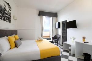 a hotel room with a large bed and a desk at Hotel Stabia in Castellammare di Stabia +55 photos