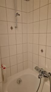 a bathroom with a bath tub with a shower at Chambre Cosy Lausanne in Lausanne