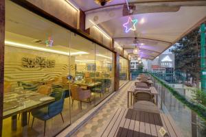 a restaurant with tables and chairs on a balcony at VRR Astoria Hotel & Convention Center in Bangalore