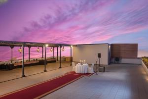 a patio with a table and a view of the ocean at Park Inn by Radisson Gwalior in Gwalior