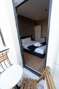 a view of a bedroom with a bed and a chair at Costera Hotel in Istanbul