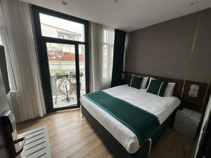a bedroom with a bed and a large window at Costera Hotel in Istanbul +67 photos