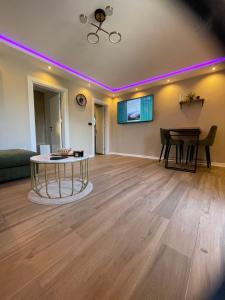 a living room with a table in the middle at Aqua Casa in Vrnjačka Banja