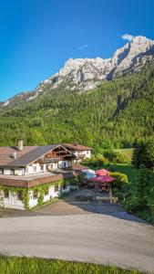 an aerial view of a building with mountains in the background at Strubwirt in Waidring