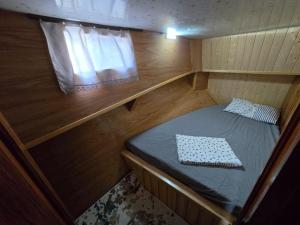 a small room with a bed in a boat at YourTourKey Gulet Accommodation in Güvercin Adası +4 photos