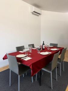 a table with chairs and a red table cloth on it at Nuovo Progetto A&E in Vicenza