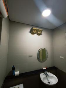 a bathroom with a sink and a mirror at J&J guest house in Hanoi