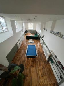 an overhead view of a living room with a pool table at The Cotswold Wellhouse in Tetbury